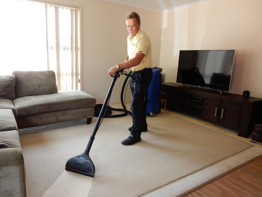 John steam cleaning a carpet.